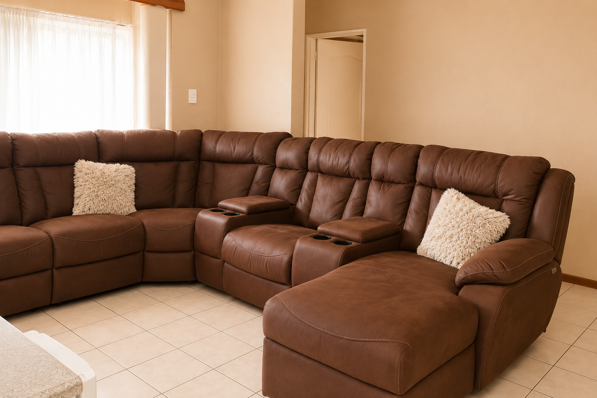 A spacious living room featuring neutral wall tones and light-colored tiled flooring, providing a clean and functional base for interior design.