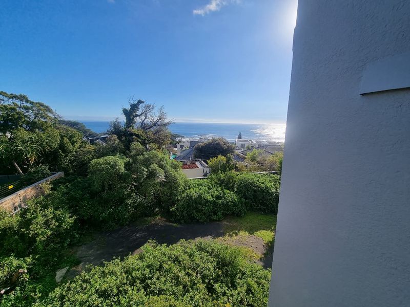 A scenic elevated view overlooking the surrounding neighborhood with a clear outlook towards the ocean.