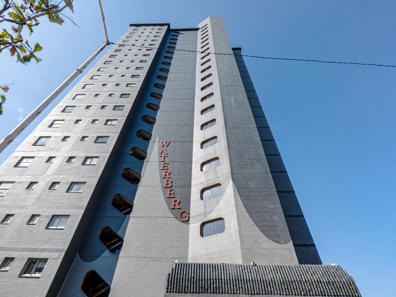 Low angle view of the Waterberg apartment building facade, showcasing its multi-story architectural design and exterior structure.