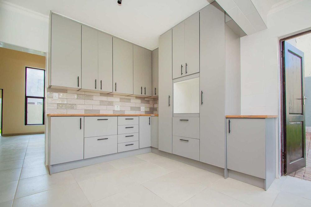 Banks of cupboards and feature subway tiles