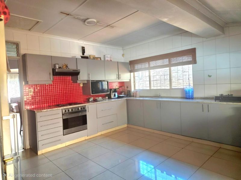 Functional kitchen featuring grey cabinetry, a vibrant red tiled backsplash, built-in oven, extractor fan, and tiled flooring.
