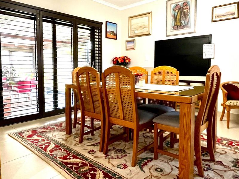 Dining room featuring tiled flooring and large sliding glass doors providing access to the outdoor area.