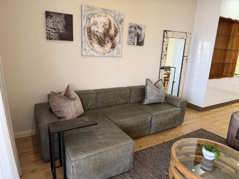 A well-maintained living area featuring modern laminate flooring and integrated built-in cabinetry, offering a clean and contemporary aesthetic.