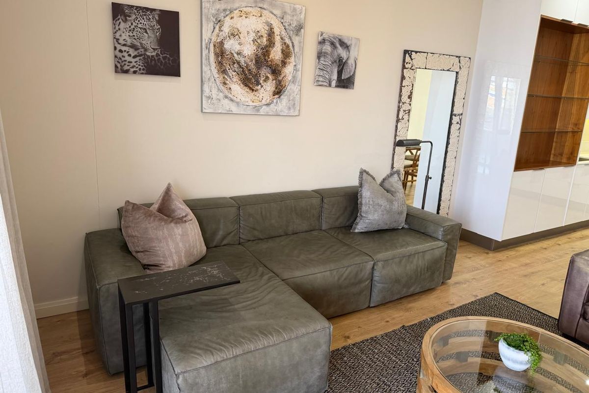 A well-maintained living area featuring modern laminate flooring and integrated built-in cabinetry, offering a clean and contemporary aesthetic.