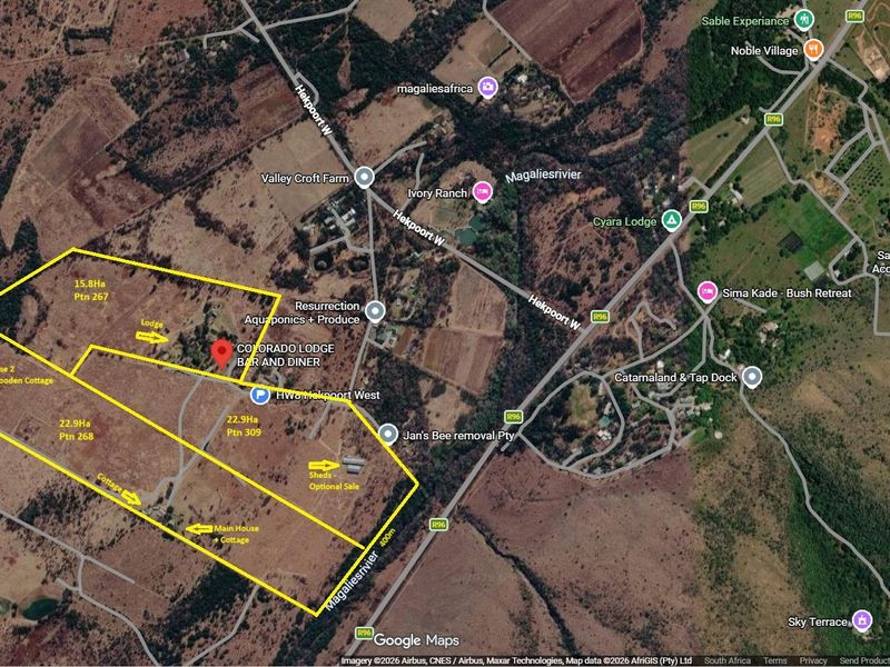 Aerial satellite view showing the property boundaries, access roads, and various structures including the main house, cottages, and sheds on the farm.