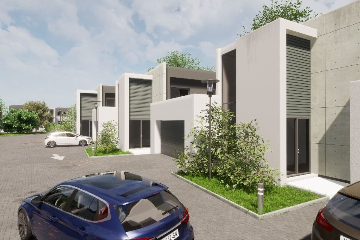 A modern residential complex featuring contemporary architectural design, paved driveways, and integrated garage access.