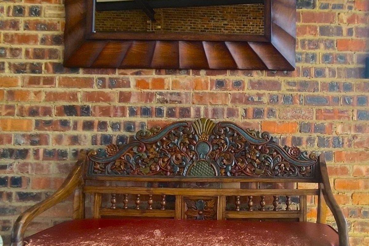 A feature wall showcasing exposed rustic brickwork, providing a textured backdrop for interior living spaces.