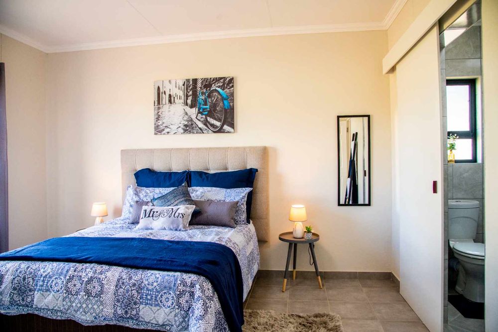 Spacious main bedroom with built-in cupboards and ensuite bathroom.