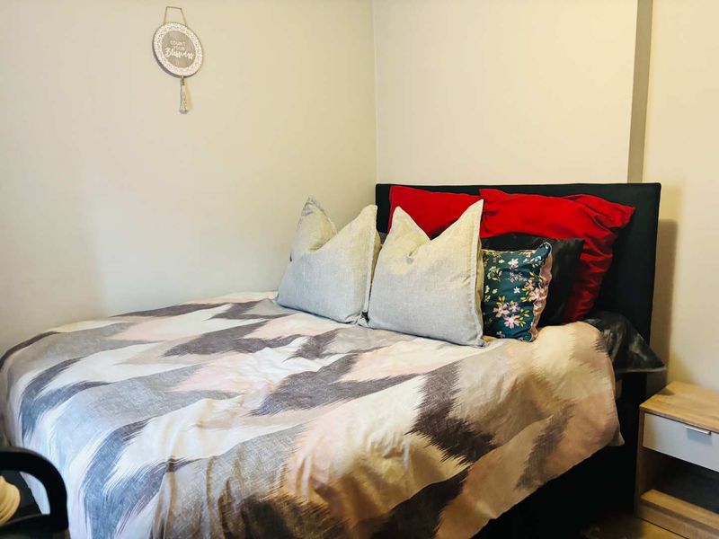 A standard bedroom featuring neutral wall finishes and a functional layout, suitable for personalizing with updated decor and lighting.