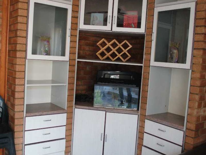 Renovated, built up, and expanded into a neat four-bedroom home with multiple living rooms and Bar area - Photo 7