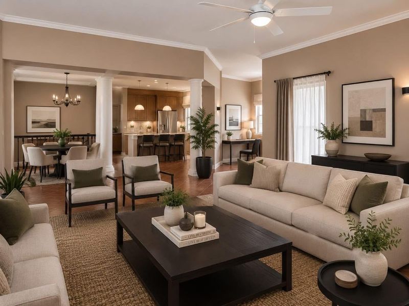Spacious open-plan living area featuring a modern kitchen with island, dining space, and comfortable lounge, all finished with elegant crown molding and neutral tones.