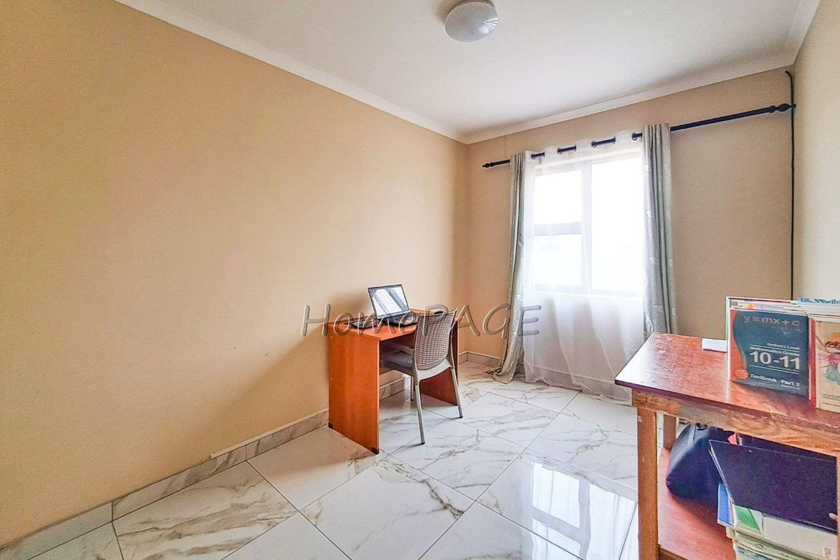 A bedroom featuring polished marble-look floor tiles, a window with curtain rod, and neutral wall finishes.