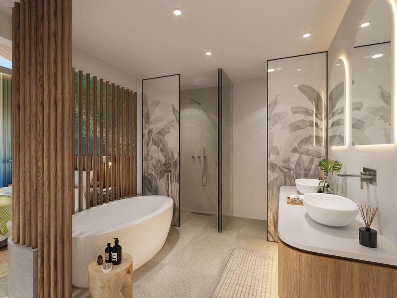Modern luxury bathroom featuring a freestanding bathtub, walk-in glass shower, dual vessel sinks on a custom vanity, and decorative wall panels.