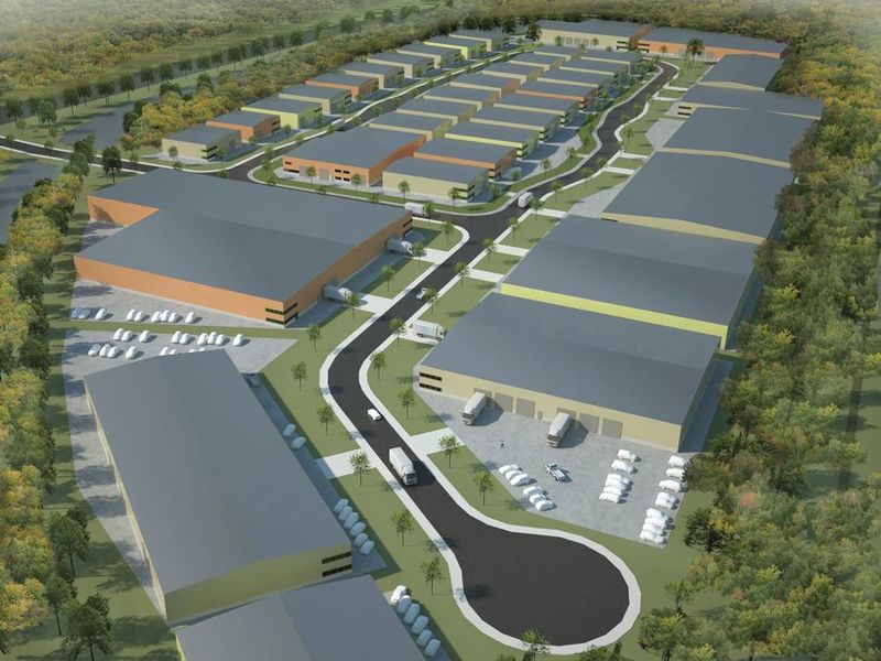 An aerial rendering of a commercial industrial park featuring multiple warehouse units, internal access roads, and dedicated parking facilities.