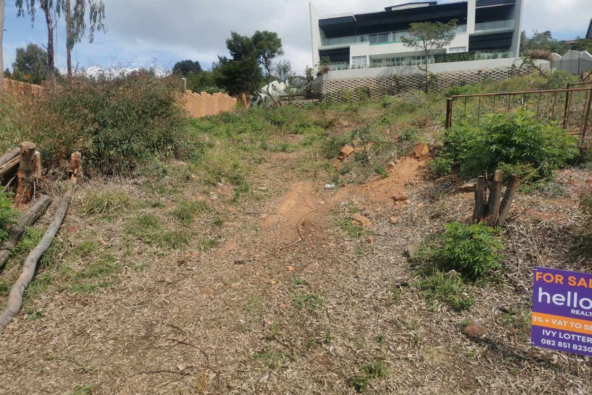 A vacant residential plot featuring natural terrain and established vegetation, offering a blank canvas for future development in a residential area.