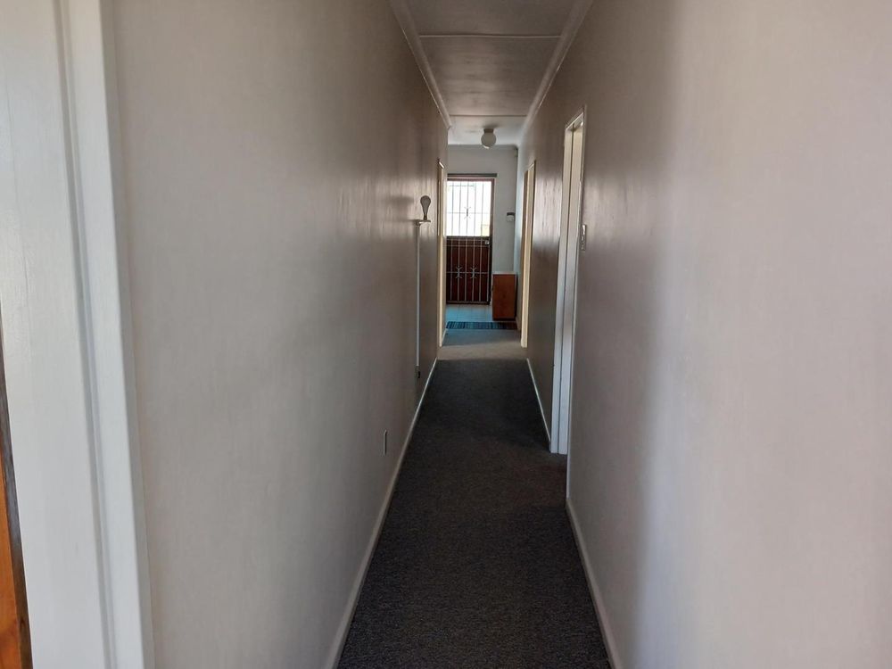 Passage leading to 2 more Bedrooms, Kitchen & Bathroom. Rear door right at the back