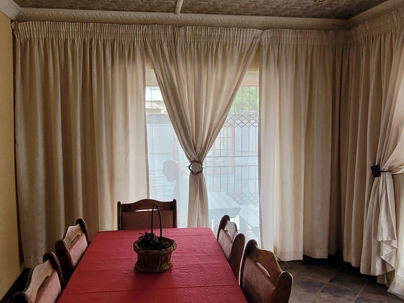 Dining room featuring tiled flooring and a large sliding glass door providing access to the exterior.