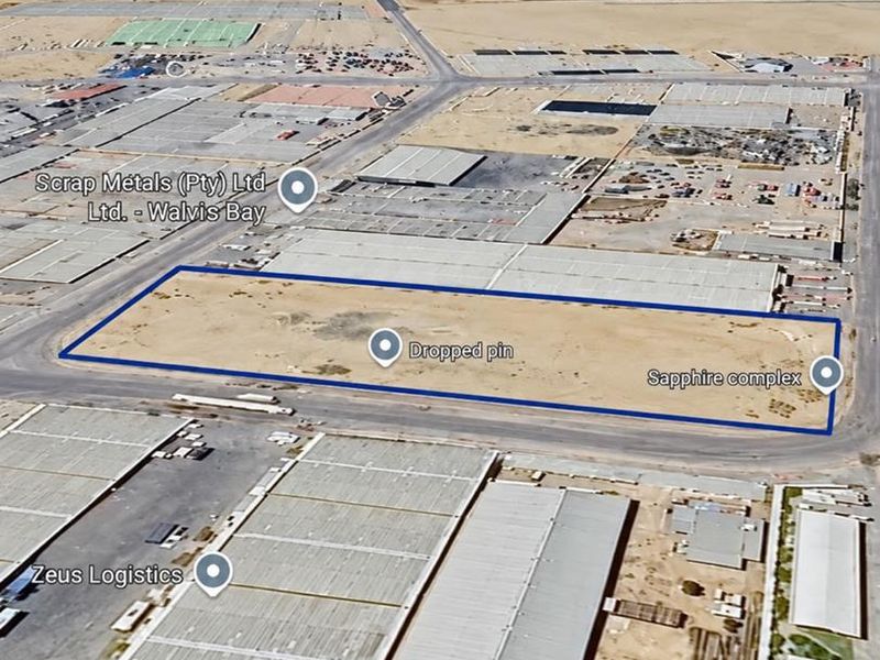 Aerial view of a vacant industrial plot situated within a developed logistics and industrial precinct, offering significant development potential.