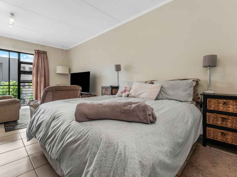Spacious bedroom featuring tiled flooring and a sliding glass door providing access to an outdoor area.