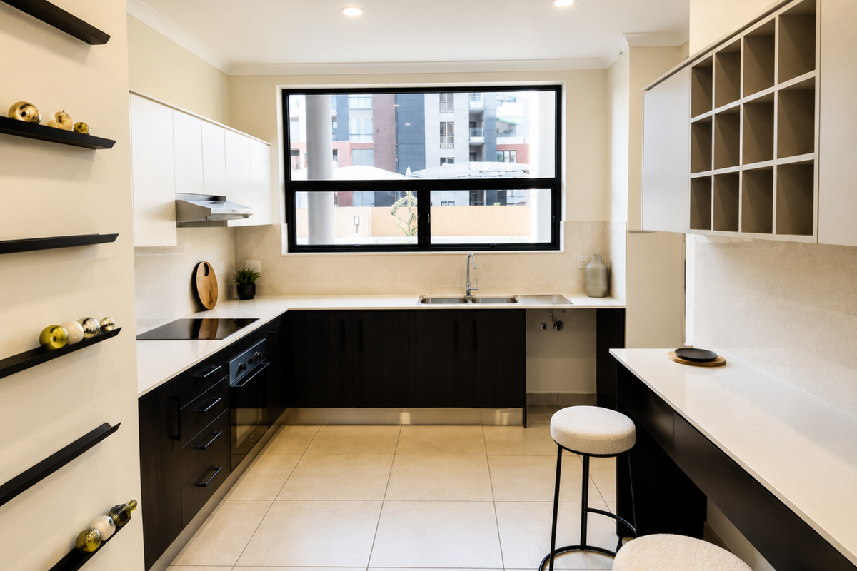 Modern kitchen featuring dark lower cabinetry, white upper cabinets, stone countertops, integrated appliances, and a convenient breakfast bar area.