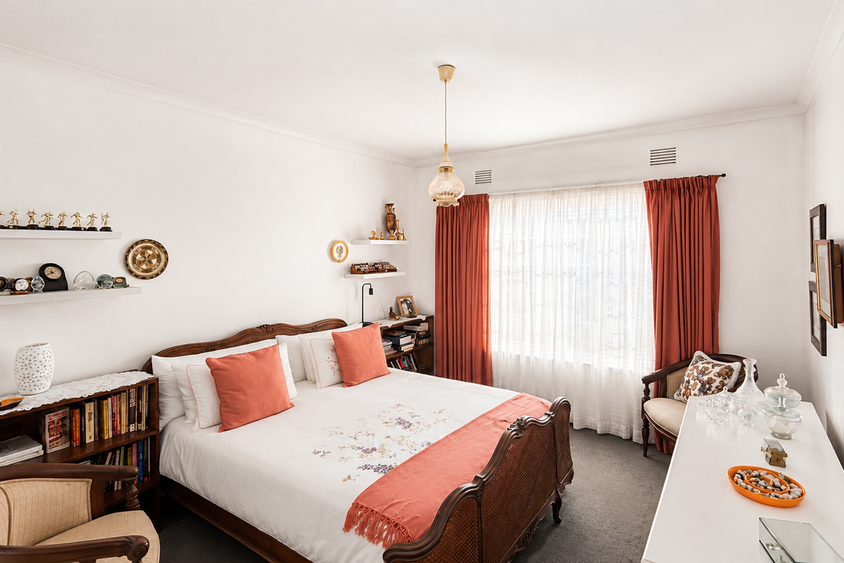 A well-maintained bedroom featuring neutral walls, carpeted flooring, and large windows with integrated curtain tracks and ventilation grilles.