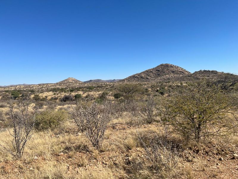 A scenic view of the natural landscape featuring rolling hills and native vegetation on this vacant residential land.