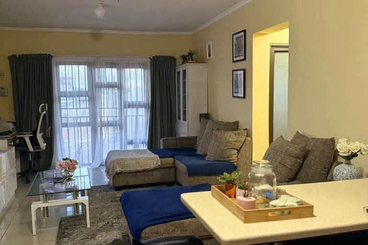 Open plan living and dining area featuring tiled flooring and a large sliding glass door providing access to the balcony.
