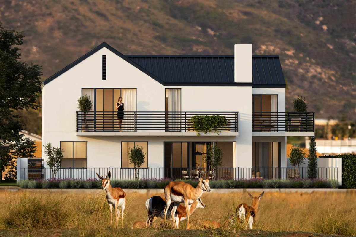 A modern two-story residential home featuring a sleek metal roof, expansive balconies with metal railings, and large sliding glass doors overlooking a natural landscape.