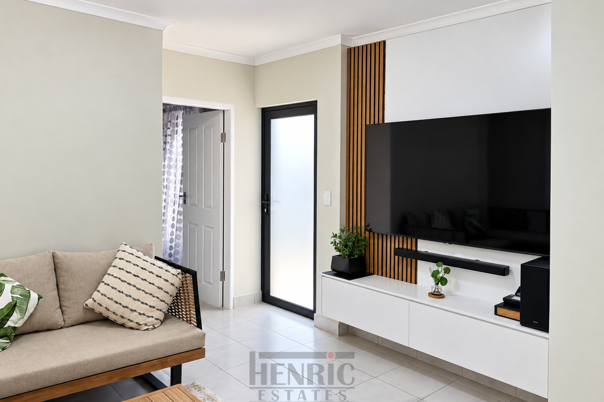 Modern living room featuring a sleek built-in media console with timber slat wall detailing, tiled flooring, and a frosted glass exterior door.