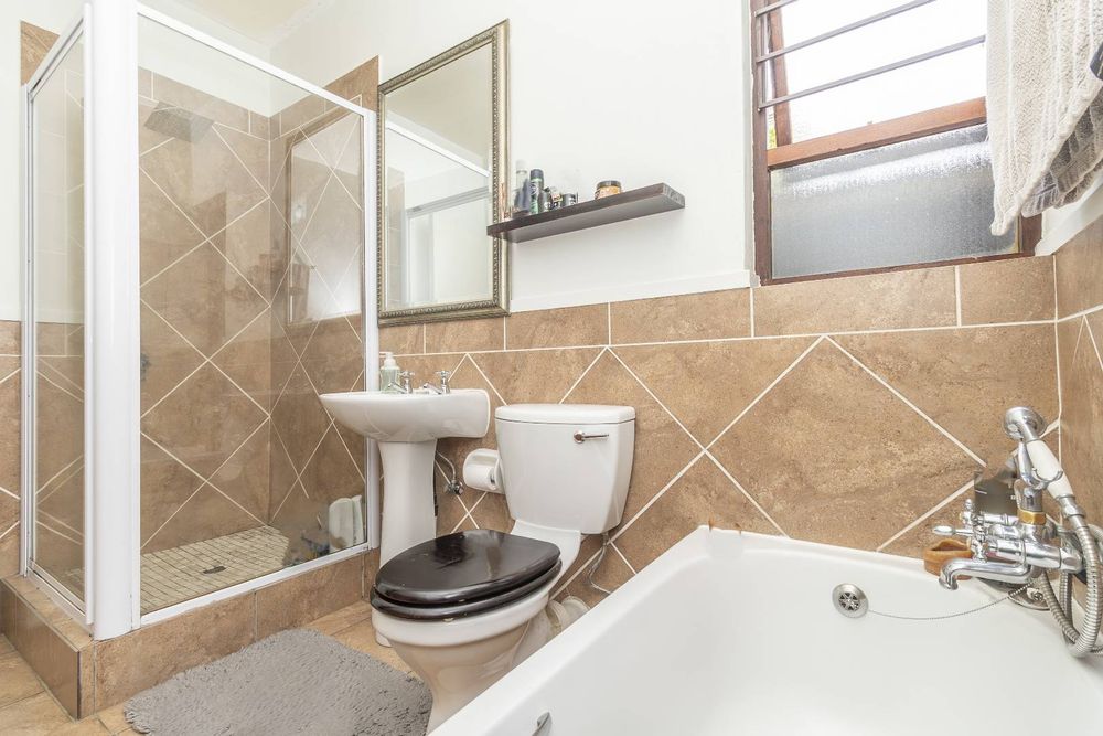 Bathroom has bathtub and shower