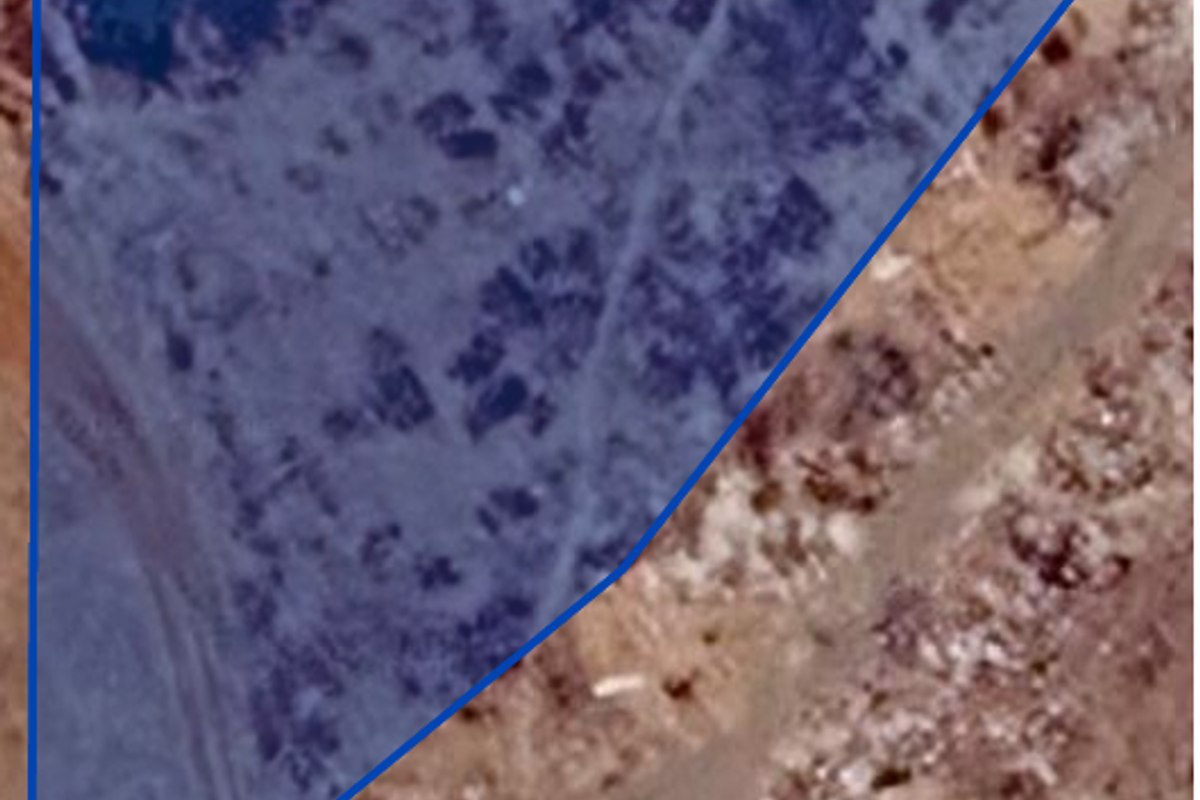 An aerial view of a vacant residential plot of land, highlighting the property boundaries.