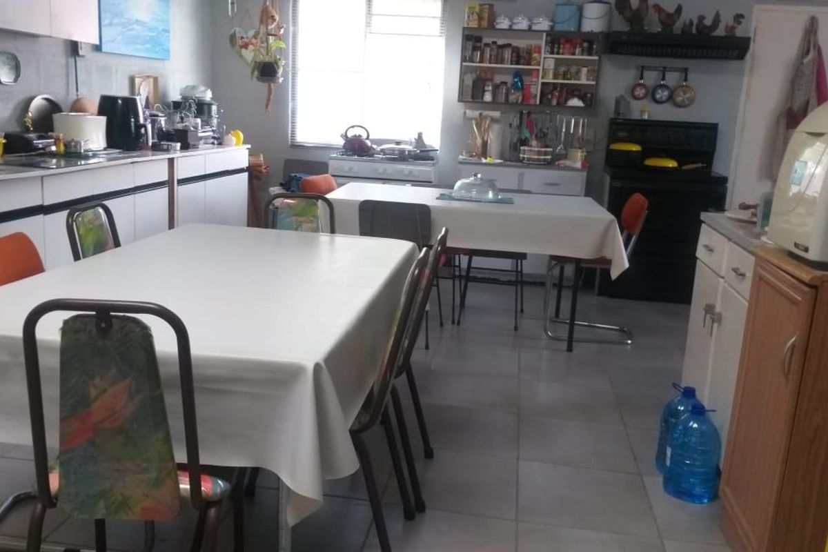 A functional kitchen space featuring tiled flooring, built-in cabinetry, and a gas stove, offering a practical layout for daily meal preparation.