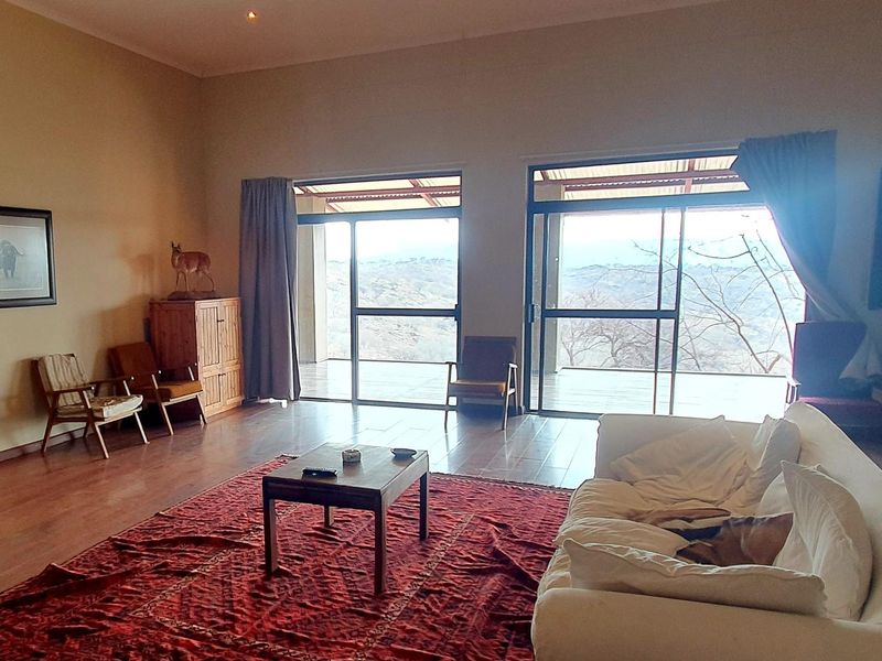 Spacious living room featuring laminate flooring and large sliding glass doors that provide natural light and access to the outdoor patio area.