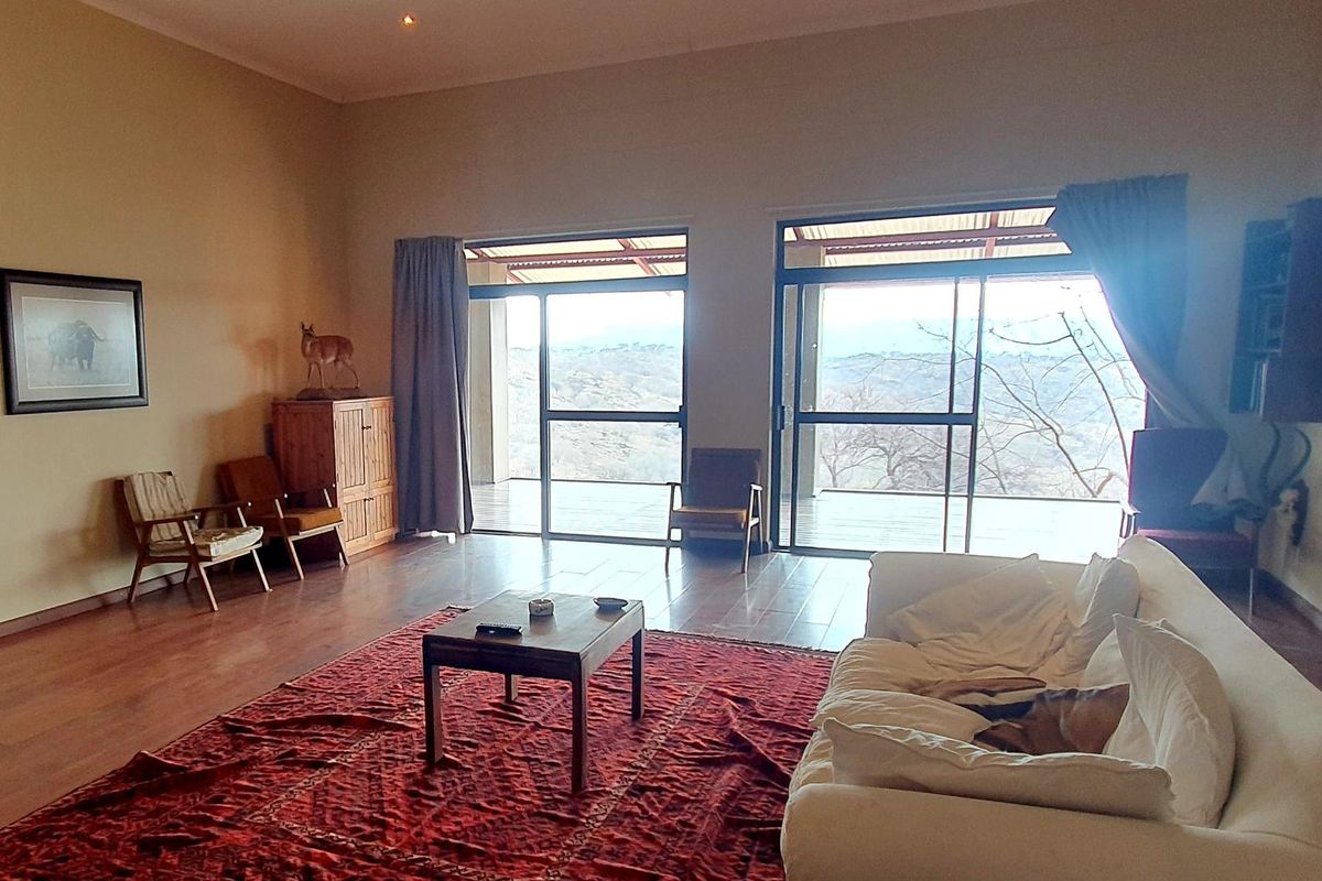 Spacious living room featuring laminate flooring and large sliding glass doors that provide natural light and access to the outdoor patio area.