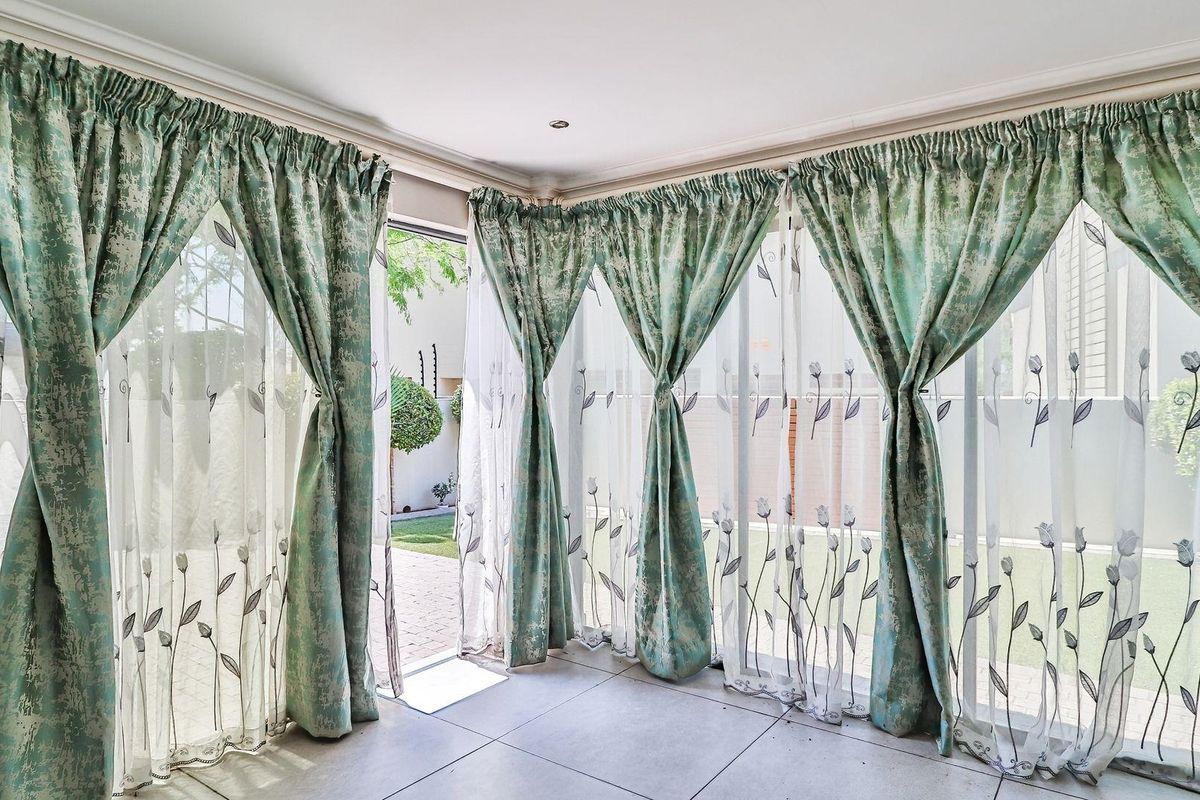 Bright living area featuring large glass sliding doors that provide seamless access to the outdoor garden space.