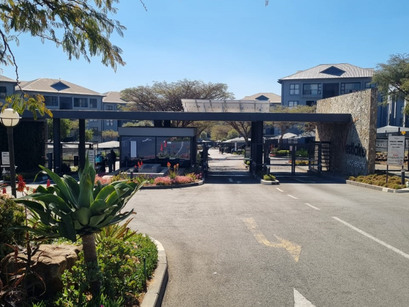 The main entrance and security gatehouse of the Westlake Eco-Estate, featuring modern stone cladding and controlled access points.