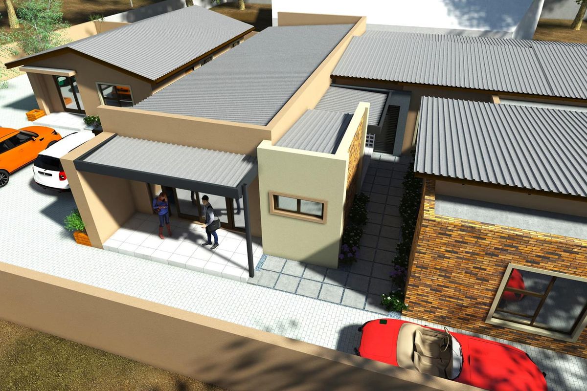 An aerial perspective of a modern residential property featuring a corrugated metal roof, brick facade accents, and paved driveway areas.