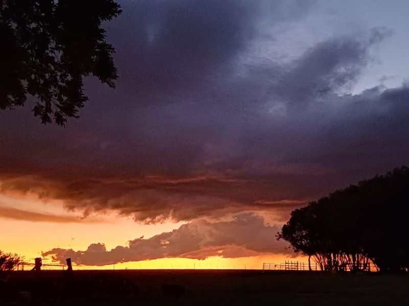 A scenic sunset view over the farm landscape, showcasing the natural beauty and open horizon of the property.