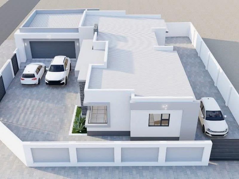 An aerial view of a modern residential property featuring a paved driveway, perimeter wall, secure gate, and a garage.