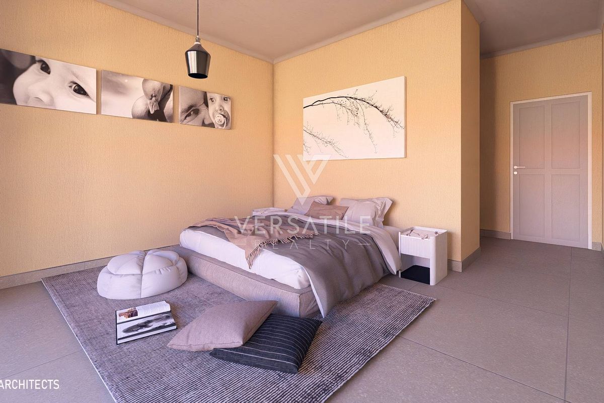 A modern, well-lit bedroom featuring neutral wall tones, tiled flooring, and a clean, minimalist architectural design.