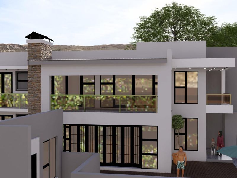 A modern two-story residential exterior featuring a stone-clad chimney, expansive glass balcony, and large bi-fold doors opening onto a deck.