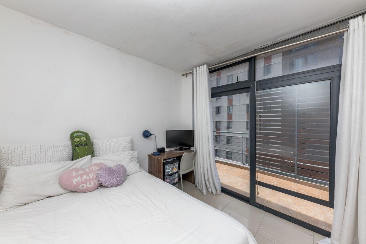Bedroom featuring tiled flooring and a large sliding glass door providing direct access to a private balcony.