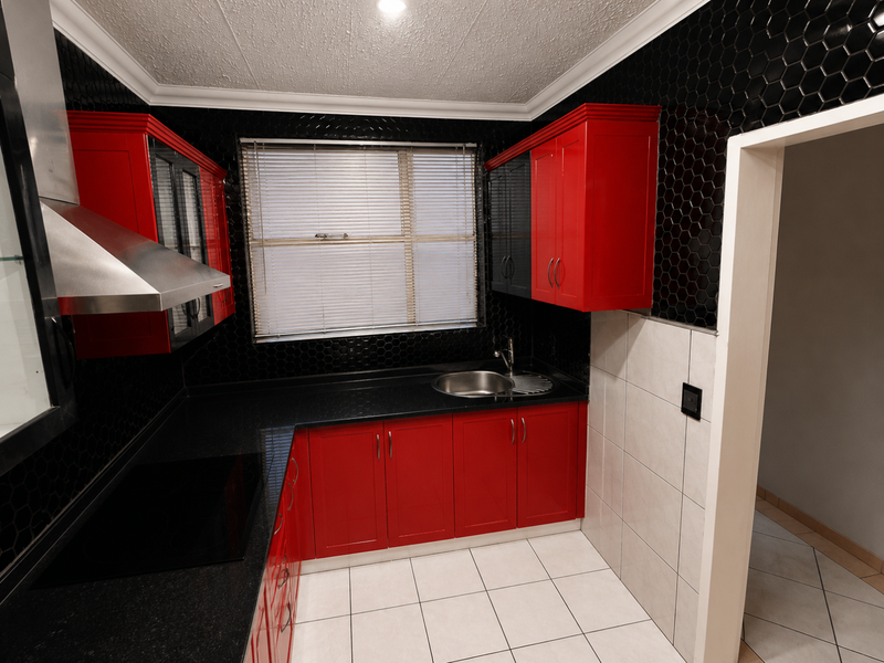 A modern kitchen featuring bold red cabinetry, black granite countertops, striking black hexagonal wall tiles, and a stainless steel extractor fan.