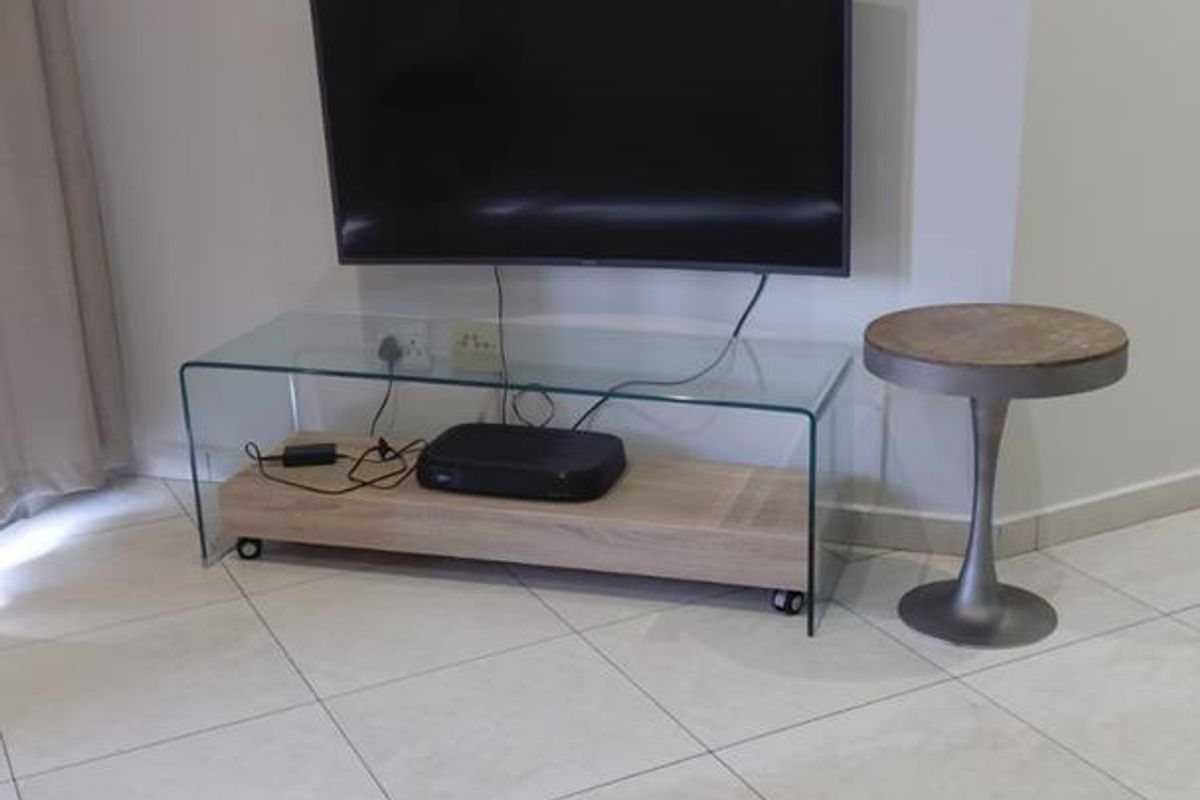A view of a living area featuring tiled flooring and neutral wall finishes.