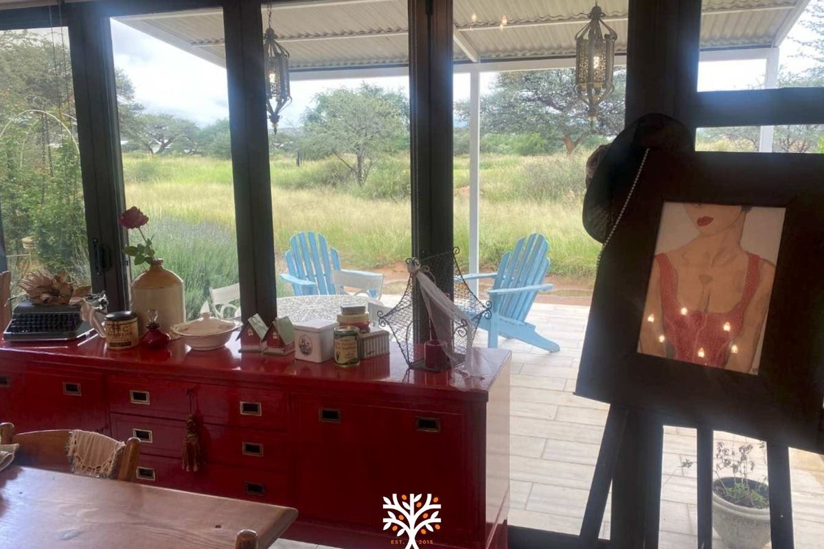 Bright living area featuring large glass sliding doors that open onto a covered patio with scenic views of the surrounding landscape.