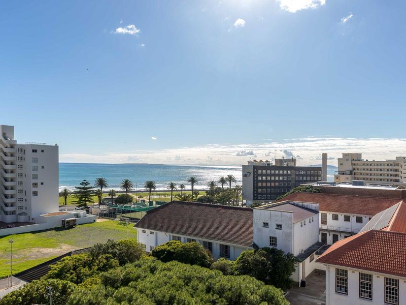 Elevated coastal view overlooking the surrounding urban landscape, parkland, and the ocean horizon.