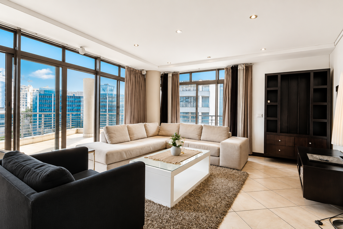 Spacious living room featuring large floor-to-ceiling sliding glass doors, tiled flooring, recessed lighting, and a built-in shelving unit with an urban city view.
