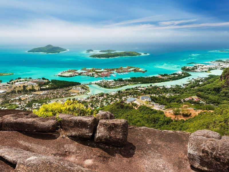 A breathtaking elevated view overlooking the coastal landscape, turquoise waters, and surrounding islands, showcasing the natural beauty of the property's location.