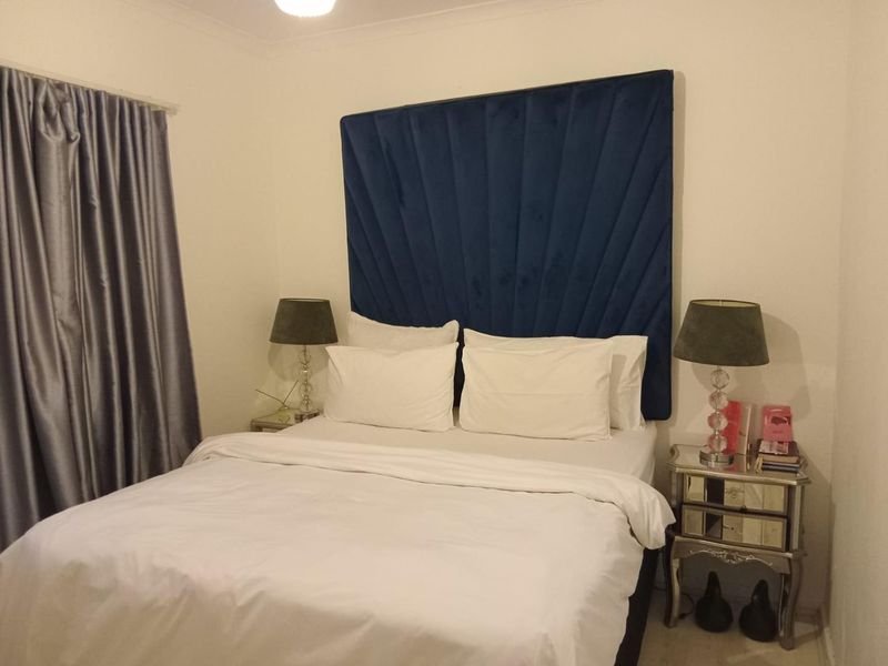 A standard bedroom featuring neutral walls, coving, and a curtain rail, providing a functional space for rest.