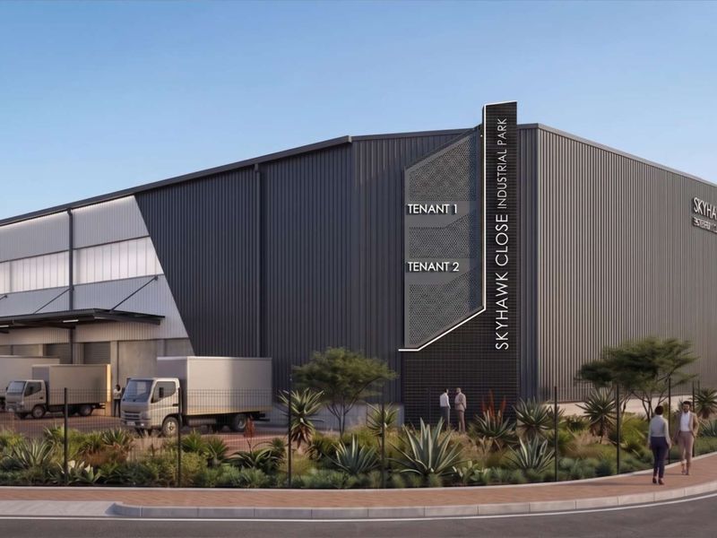 Modern industrial warehouse facility featuring corrugated metal cladding, dedicated loading bays, and professional signage within Skyhawk Close Industrial Park.
